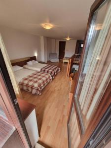 a hotel room with two beds and a balcony at Mountain Paradise 1 - 1 Bedroom Homey Two Floor Apartment - Washer in Bansko