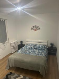 a bedroom with a bed in a white room at Appartement T2 in Dax