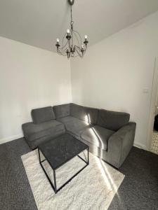 a living room with a couch and a table at Cozy Double Room with 5 Minute Walk to Anfield Stadium ideal for Matchdays in Liverpool
