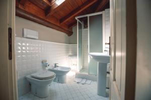 a bathroom with a toilet and a sink at Villa Mimosa au Lac - Estella Hotels Italia in Toscolano Maderno +64 photos