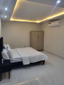 a bedroom with a large bed and a cabinet in it at Crystal Heights in Lahore
