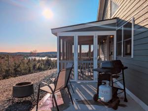 a screened in porch of a house with a grill at Acadia Sunset Fishing Cabin #1 family beach 1 dog in Sullivan