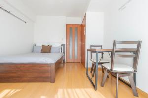 una camera da letto con un letto, un tavolo e delle sedie di 森下駅徒歩2分 両国 東京スカイツリー直通の快適ステイ Dsx a Tokyo
