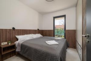 a bedroom with a large bed and a window at Balaton Flow Residence in Fonyód +102 photos
