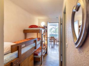a room with four bunk beds and a mirror at Studio 5 pers. proche pistes, balcon, casier à skis, non-fumeur - FR-1-404-81 in La Mongie