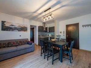 a living room with a table and chairs and a couch at Residence Valtellina - Appartamento centrale vicino salita Baradello in Le Bratte +21 photos