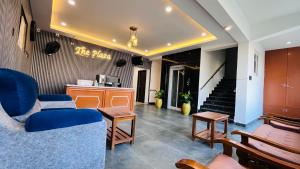 a lobby with blue chairs and a table and stairs at THE PLAZA, Very Close to Indira Gandhi Square, Near Sri Kamatchi Hotel, 100 feet Road, PONDICHERRY - BMC in Pondicherry