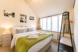 a small bedroom with a bed and a window at Church Farm Country Cottages in Freshford +43 photos