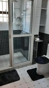 a bathroom with a shower and a toilet in it at Leslie's Apartment in Nalakonge