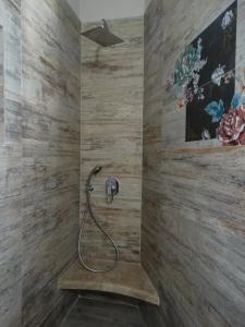 a shower with a hose attached to a wall at Skopelitis Village in Katapola