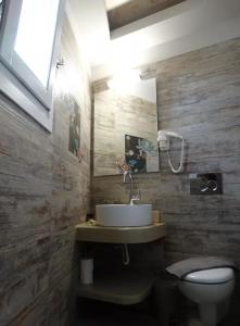 a bathroom with a sink and a toilet at Skopelitis Village in Katapola