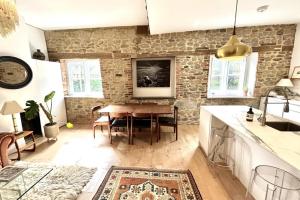 a kitchen and dining room with a wooden table at Petworth Cottage-Sleeps 6-Pet Friendly-Central in Petworth