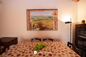 a dining room table with a painting on the wall at La Dimora dell'Artista in Manerba del Garda +44 photos