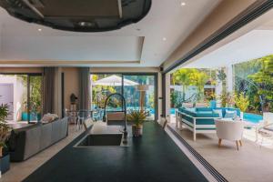 an open living room with a pool and furniture at Villa Ayana - Premium Mauritius Stay in Grand Baie