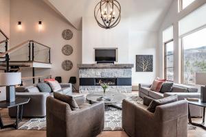 a living room with couches and a fireplace at Havre Ride-Out 113 Luxurious & Modern Direct Ski-in Ski-out in Mont-Tremblant