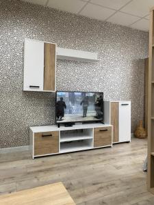 a living room with a flat screen tv at Панорама in Panagyurishte