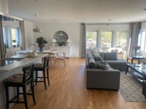 a living room with a couch and a table at villa near Åda golf in Trosa