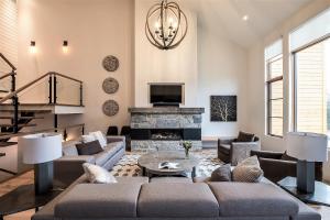 a living room with a couch and a fireplace at Havre 117 Tremblant Luxurious & Modern Ski-in Ski-out in Mont-Tremblant