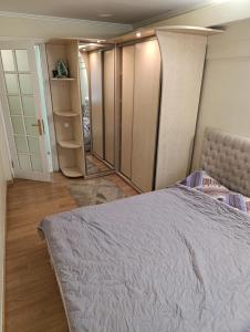 a bedroom with a large bed and a closet at Apartment on Privokzalnaya 2/1 in Vinnytsya +17 photos