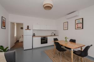 a kitchen and dining room with a table and chairs at Napbogár Vendégház in Balatongyörök