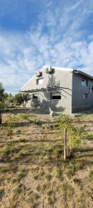 a white building in the middle of a field at Finca san benito in Puerto Madryn