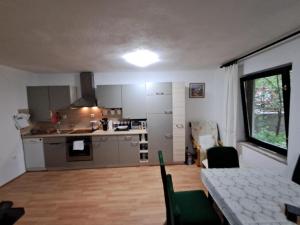 a kitchen with a table and a dining room at Kuca za odmor Amber in Bihać