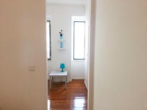 an empty hallway with a table and a window at Alcantara Quiet & Calm in Lisbon in Lisbon