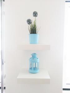 a shelf with a blue lantern and a plant at Alcantara Quiet & Calm in Lisbon in Lisbon
