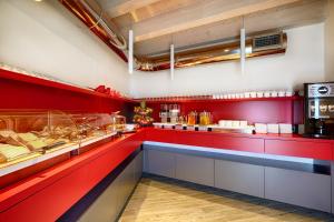 a fast food restaurant with red walls and a counter at Hospitality Hotel in Palermo
