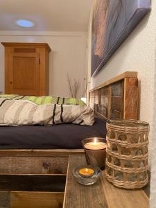 a bedroom with a bed and a table with a candle at Kutscherwohnung in Kiel
