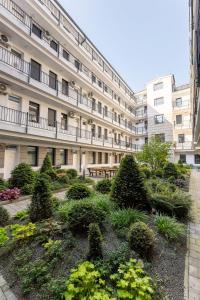 an apartment building with a garden in front of it at Magnolia Apartment Hotel in Budapest