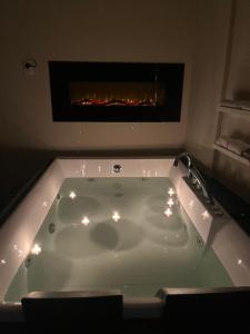 a bath tub in a room with a fireplace at La Corte dei Prefetti di Vico Bellavista Relax in Ronciglione +31 photos