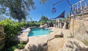 a small pool of water in a rock garden at Arribes del Duero casa rural Balneario, hotel rural Bermellar y Camino de Hierro in Bermellar