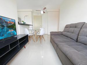 a living room with a couch and a table at 2 Bedrooms Cozy Parking in Carapicuíba