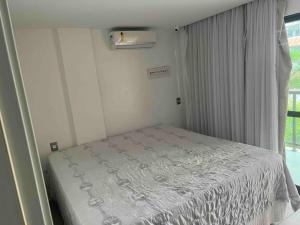 a small bed in a room with a window at Complete beach house! in Cabedelo +27 photos