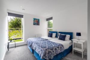 a bedroom with a bed and two windows at free parking,Top location, Shops in Edgware