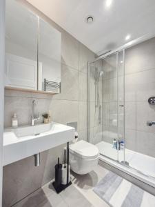 a bathroom with a sink and a toilet and a shower at Regents Park 3-BR flat w. balcony near Marylebone in London +226 photos