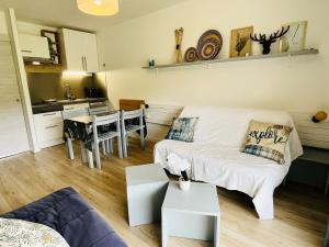 a living room with a couch and a table at Le Vert Montagne Studio lumineux plein sud in Le Dévoluy