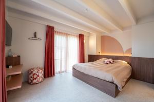 a bedroom with a bed and a large window at De Rietreiger in Blankenberge