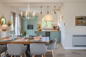 a kitchen with a dining room table and chairs at Villa Vita by Villas Guide in Vranići