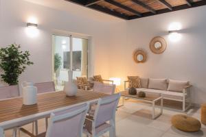 a living room with a wooden table and chairs at Villa Serena Blanca by Villalia Luxury Oasis & Private Pool in Playa Blanca