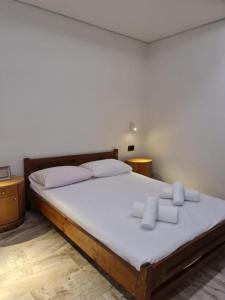 a bedroom with a large bed with white sheets at Sarri Appartments in Amoudara Herakliou