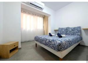 a bedroom with a bed and a dresser and a window at Boetman in Saint-Raphaël