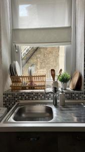 a sink in a kitchen with a window and a sink at Casa Caterina in Lezzeno +79 photos