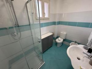 a bathroom with a shower and a sink and a toilet at Residence San Francesco in Tirrenia