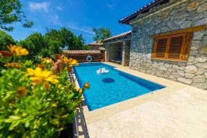 a swimming pool in the backyard of a house at Carevic Resort & Villas in Budva