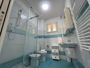 a bathroom with a toilet and a sink and a shower at Residence San Francesco in Tirrenia
