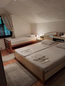 a bedroom with two beds and a window at Kuca za odmor Amber in Bihać