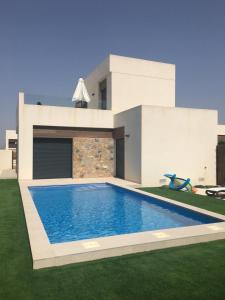 a house with a swimming pool in the yard at Villa dans un magnifique golf in Algorfa