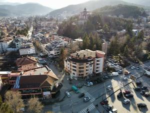 an aerial view of a city with cars parked in a parking lot at Oblivion in Velingrad